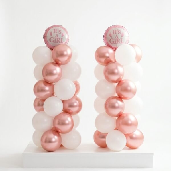 Baby Girl Celebration Column: two columns of white and rose gold chrome balloons topped with round 'It's a Girl' foil balloons on a white stand