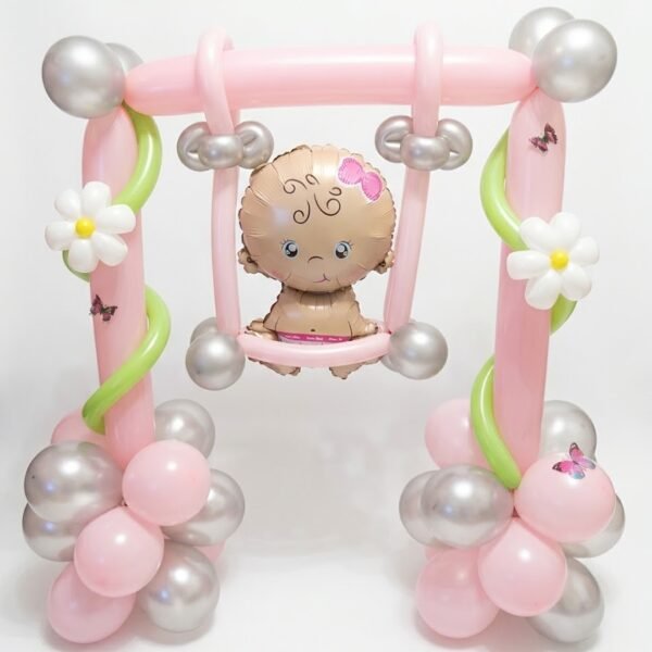 Baby Girl Premium Balloons: pink balloon swing with a baby girl foil balloon, white daisies, green vines, pink and silver balloon bases