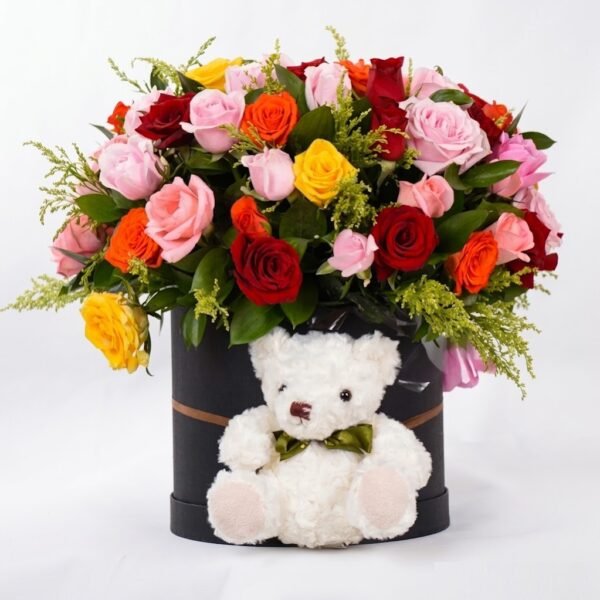 Colorful Flower Box with White Teddy Bear Colorful Flower Box: red, pink, orange and yellow roses with solidago in a black round box with a white teddy bear in front