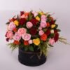 Colorful Flower Box: pink, red, orange and yellow roses with solidago in a black velvet round box tied with a brown ribbon
