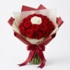 Crimson Heart Bouquet from above: a white rose at the centre of tightly packed red roses