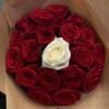Crimson Heart Bouquet from above: a white rose at the centre of tightly packed red roses