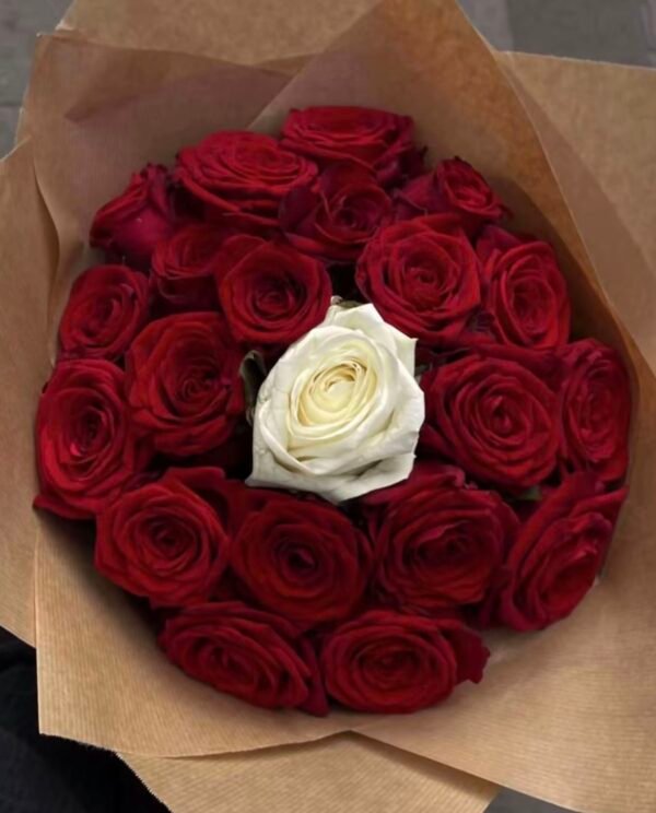 Crimson Heart Bouquet from above: a white rose at the centre of tightly packed red roses