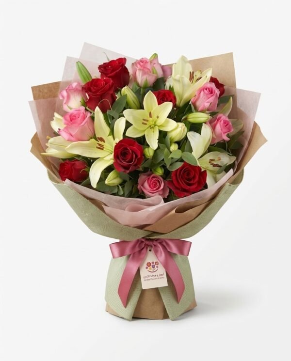 Lily & Roses bouquet of white lilies with red and pink roses in pink and green wrap with a bow