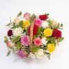 The full Mini Mix Bloom Basket arrangement: red, pink, yellow, white and lilac roses with white chrysanthemums around the wicker handle
