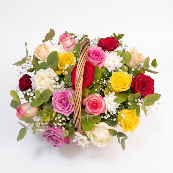 The full Mini Mix Bloom Basket arrangement: red, pink, yellow, white and lilac roses with white chrysanthemums around the wicker handle