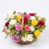 Mini Mix Bloom Basket on a white background: a round wicker basket of mixed red, pink, lilac, yellow and white roses with baby's breath