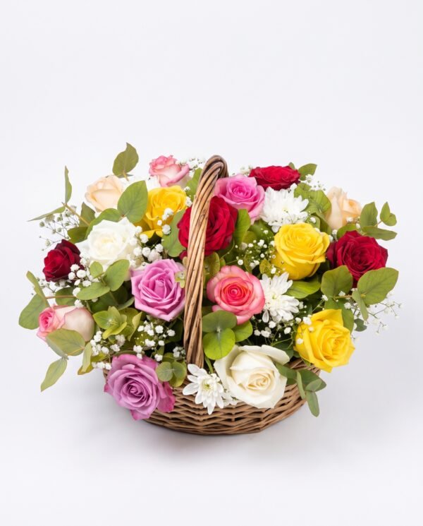Mini Mix Bloom Basket on a white background: a round wicker basket of mixed red, pink, lilac, yellow and white roses with baby's breath