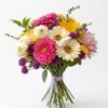 Mixed Flowers Bouquet of pink, cream and yellow gerberas, white button mums and purple pompom flowers, with bare stems tied with a lavender ribbon