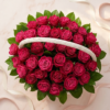 Radiant Ruby Basket seen from above: ruby roses and green leaves under a white basket handle