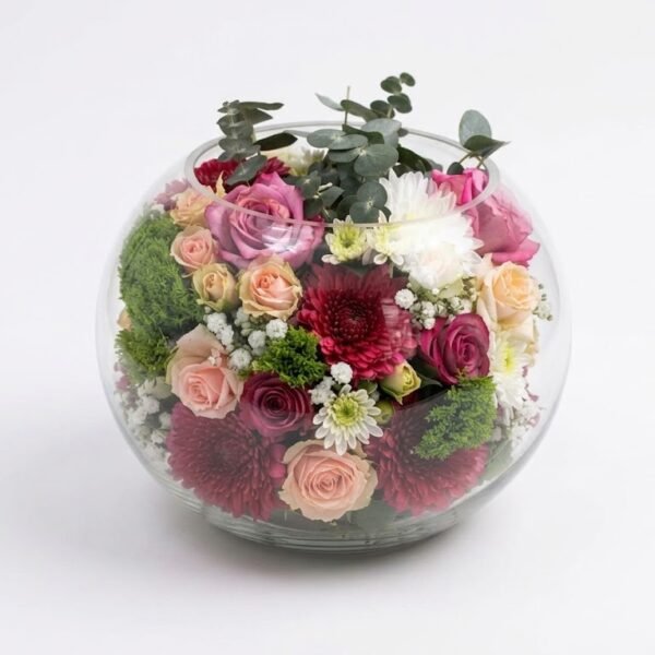 Rosé In Glass Rosé In Glass: peach and mauve roses, burgundy and white chrysanthemums, baby's breath and eucalyptus in a round glass bowl
