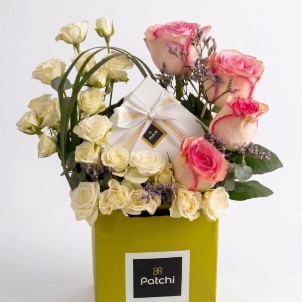 Patchi Chocolate with Pink and White Roses Patchi Chocolate with Pink and White Roses: pink roses, white spray roses and purple statice around a white Patchi box, set in a square green Patchi flower box